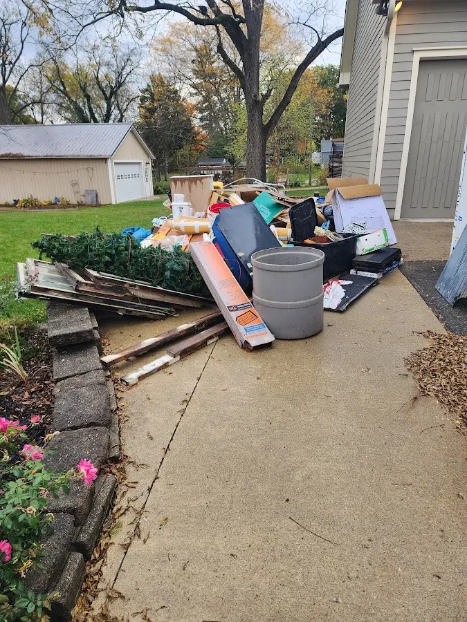 Dumpster being loaded with debris for Estate Cleanout Dumpster Rental in Milton-Freewater